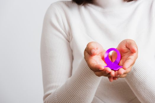 National Epilepsy or Alzheimer disease Day. Young woman holding purple ribbon on hand symbol of Pancreatic cancer, Epilepsy awareness and world Lupus Day and world cancer isolated white background