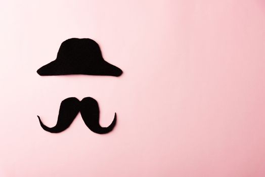 Black mustache and cap, studio shot isolated on pink background, Prostate cancer awareness month, Fathers day, minimal November moustache concept