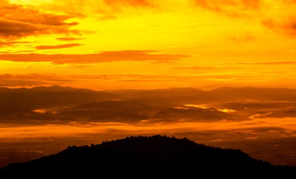 Beautiful landscape at sunset sky with clouds on peak of mountains.