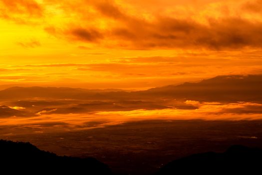 Beautiful landscape at sunset sky with clouds on peak of mountains.