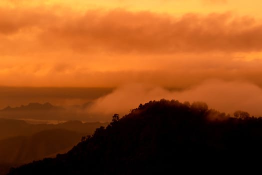 Beautiful landscape at sunset sky with clouds on peak of mountains.