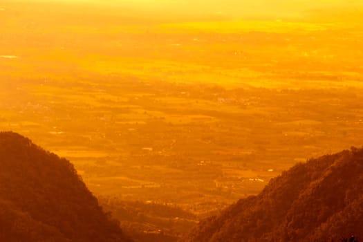 Beautiful landscape at sunset sky with clouds on peak of mountains.