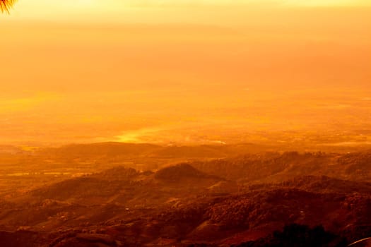 Beautiful landscape at sunset sky with clouds on peak of mountains.