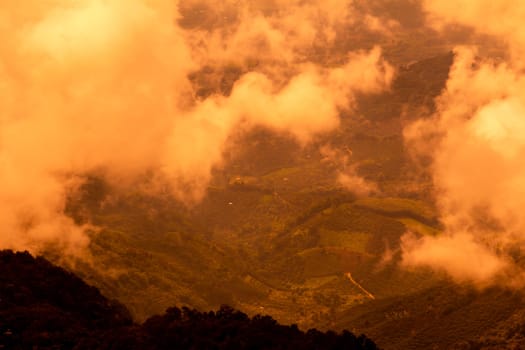 Beautiful landscape at sunset sky with clouds on peak of mountains.