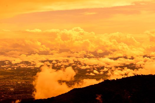 Beautiful landscape at sunset sky with clouds on peak of mountains.