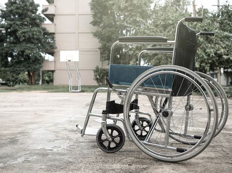 Empty wheelchair parked in the park.