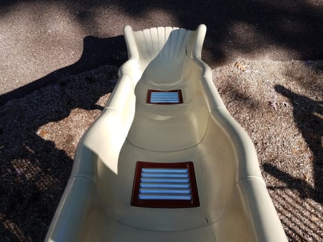 metal rollers on plastic playground play structure slide at park