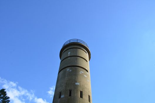 tall cement tower structure or building with blue sky