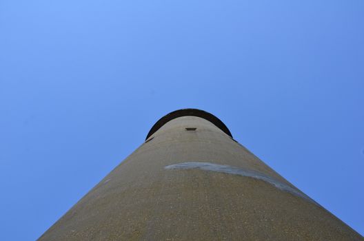 tall cement tower structure or building with blue sky