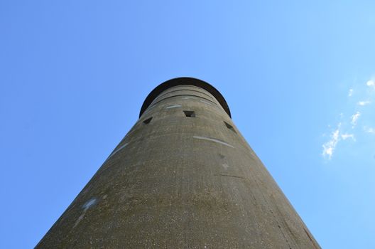 tall cement tower structure or building with blue sky