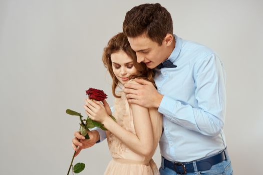 lovers men and woman hugs romance love red rose light background. High quality photo