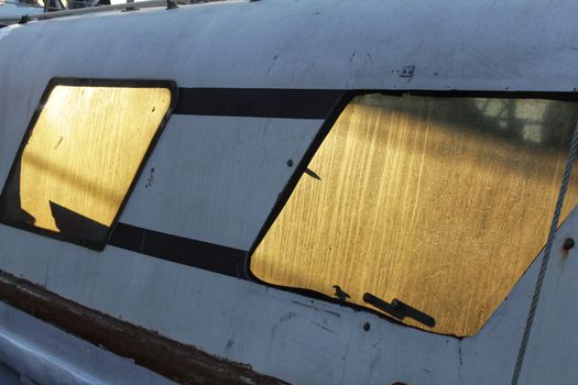 Sun reflected in the window of a fishing vessel in southern Spain