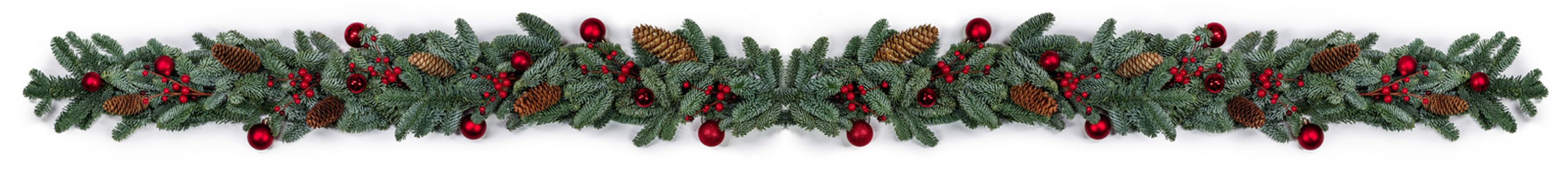 Christmas border frame design copmosition of noble fir tree branch and red decorations balls baubles berries cones isolated on white background