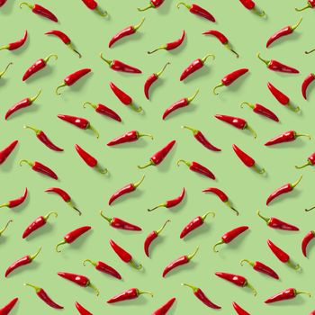 Red hot chilli seamless peppers pattern. Seamless pattern made of red chili or chilli on green background. Minimal food pattern. Food background.