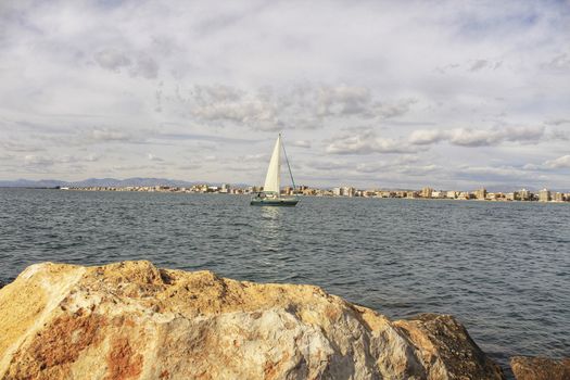 Sailboat entering the port of Santa Pola, Spain