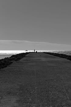 Fishing day on a breakwater under the sun in Santa Pola, Spain