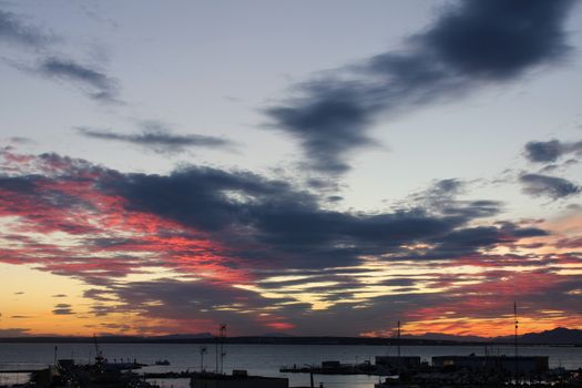 Spectacular and colorful sunset in the bay of Santa Pola, Alicante, Spain in autumn