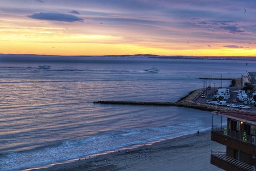 Spectacular and colorful sunset in the bay of Santa Pola, Alicante, Spain in autumn