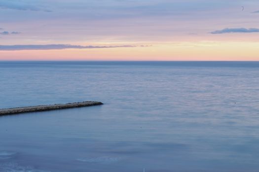 Spectacular and colorful sunset in the bay of Santa Pola, Alicante, Spain in autumn