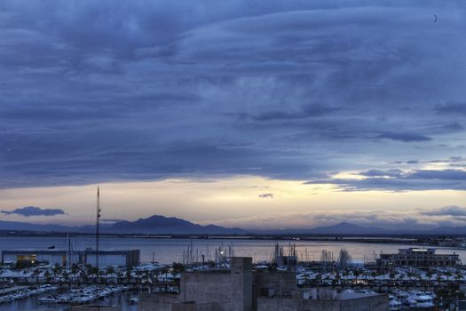 Spectacular and colorful sunset in the bay of Santa Pola, Alicante, Spain in autumn