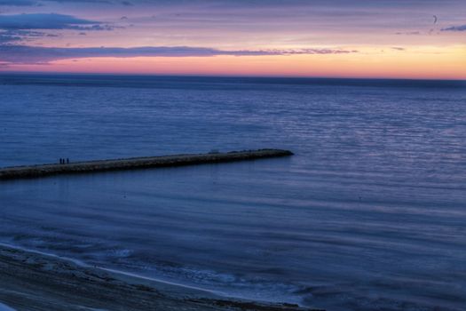 Spectacular and colorful sunset in the bay of Santa Pola, Alicante, Spain in autumn