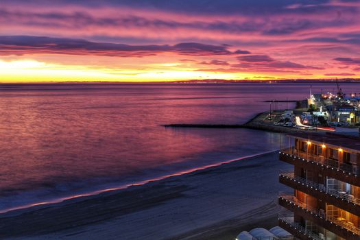 Spectacular and colorful sunset in the bay of Santa Pola, Alicante, Spain in autumn