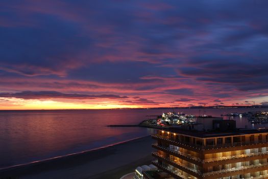 Spectacular and colorful sunset in the bay of Santa Pola, Alicante, Spain in autumn