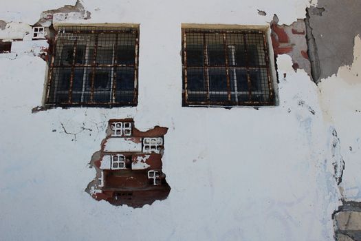 Old and damaged wall texture with windows