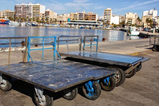 Metal trolleys to carry boxes of fish in the fishing port in Santa Pola, Alicante