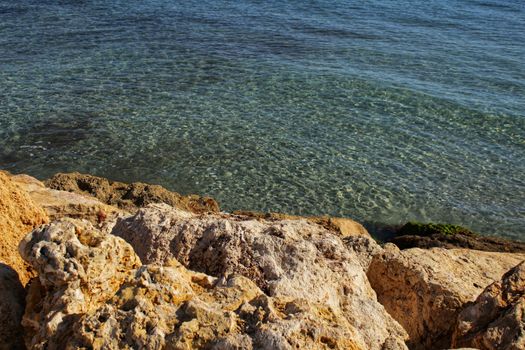 Crystal clear water and rocks on the beach in the morning