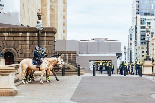 Melbourne, Australia - October 18, 2020: Victoria police patrol Melbourne CBD streets and Parliament on horseback, checking on people during the Coronavirus pandemic and associated lockdown.