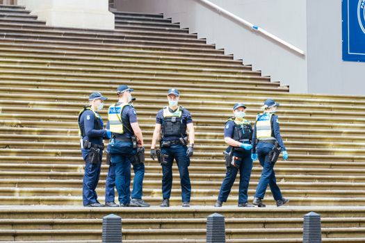 Melbourne, Australia - October 18, 2020: Victoria police patrol Melbourne CBD streets and Parliament, checking on people during the Coronavirus pandemic and associated lockdown.