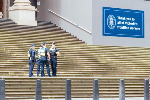 Melbourne, Australia - October 18, 2020: Victoria police patrol Melbourne CBD streets and Parliament, checking on people during the Coronavirus pandemic and associated lockdown.