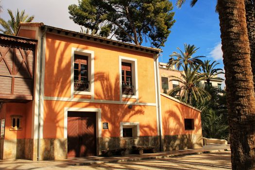 Elche, Spain- 14 February, 2018: Typical and colorful house in a palm orchard in Elche, Spain on a sunny day. Huerto de San Placido.