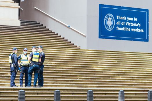 Melbourne, Australia - October 18, 2020: Victoria police patrol Melbourne CBD streets and Parliament, checking on people during the Coronavirus pandemic and associated lockdown.