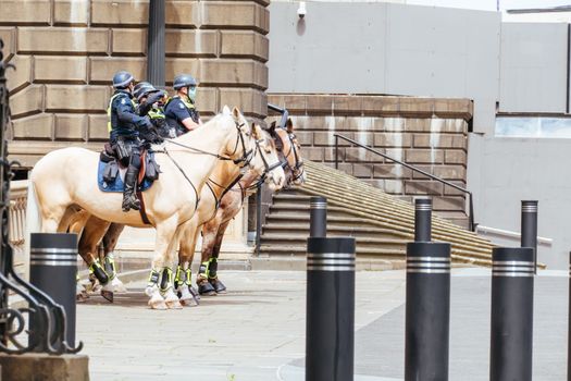 Melbourne, Australia - October 18, 2020: Victoria police patrol Melbourne CBD streets and Parliament on horseback, checking on people during the Coronavirus pandemic and associated lockdown.
