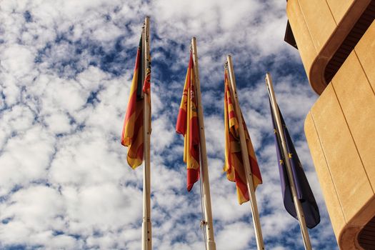Santa Pola, Spain- February 16, 2018: Constitutional flags of Spain and Europe at the city hall in a cloudy day
