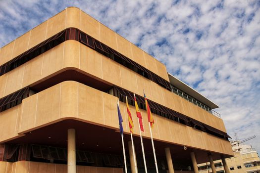 Santa Pola, Spain- February 16, 2018: Constitutional flags of Spain and Europe at the city hall in a cloudy day