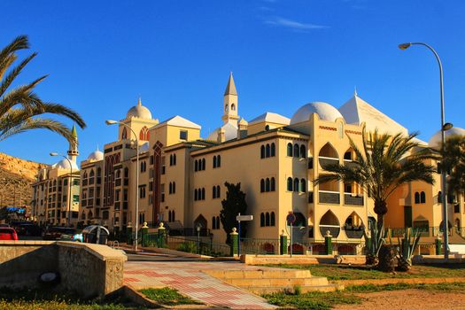 Santa Pola, Spain- February 20, 2018: Beautiful and colorful Arab-style urbanization on the coast of Santa Pola, Alicante, in a sunny day under blue sky