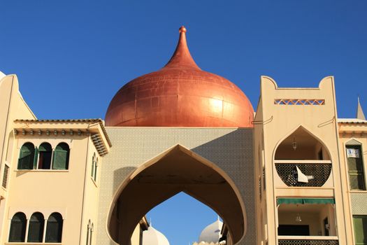 Santa Pola, Spain- February 20, 2018: Beautiful and colorful Arab-style urbanization on the coast of Santa Pola, Alicante, in a sunny day under blue sky