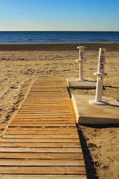 Footbath shower and walkway to the beach in the morning in a cloudy day
