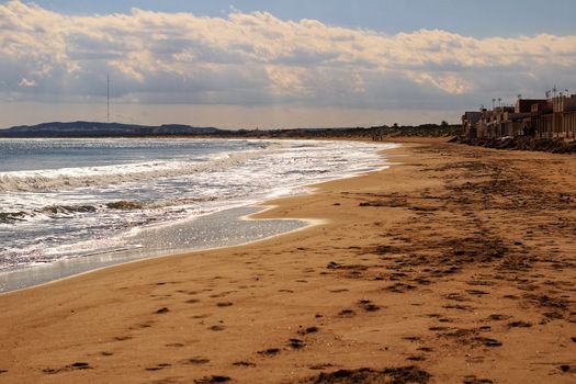 Sunny day on the beach in winter in La Marina, Alicante
