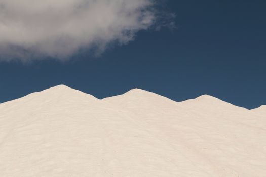 Salt mountains under blue sky in Santa Pola, Spain