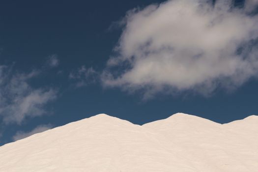 Salt mountains under blue sky in Santa Pola, Spain