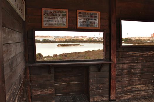 Santa Pola, Spain- March 18, 2018: Lookout for migratory birds in Santa Pola. Wetland of the salinas in the background