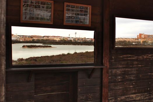 Santa Pola, Spain- March 18, 2018: Lookout for migratory birds in Santa Pola. Wetland of the salinas in the background