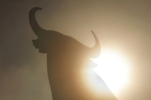 Santa Pola, Alicante, Spain- February 20, 2020: Silhouette of the mythical and typical spanish Osborne bull in the salt pans of Santa Pola, Alicante on a foggy day