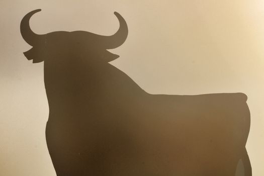 Santa Pola, Alicante, Spain- February 20, 2020: Silhouette of the mythical and typical spanish Osborne bull in the salt pans of Santa Pola, Alicante on a foggy day