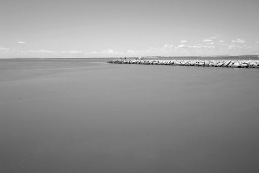 Fishing day on a breakwater under the sun in Santa Pola, Spain