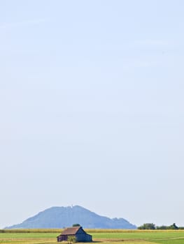 barn with a hill in the background